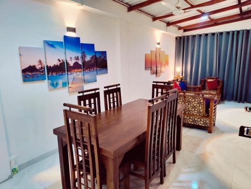 comedor con mesa de madera y sillas en Araliya Uyana Residencies Colombo - Entire House with Two Bedrooms, en Colombo