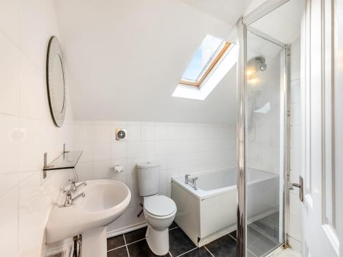 a white bathroom with a toilet and a sink at Rose Cottage - Uk45971 in Yarm