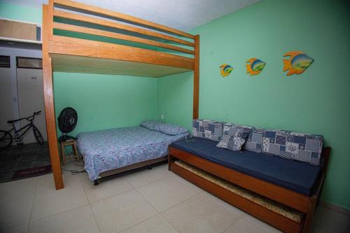 a bedroom with a bed and a bunk bed at Praia do Francês Condomínio Imperial in Marechal Deodoro