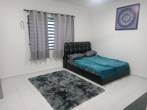 uma sala de estar com um sofá e um tapete em Homestay an nur em Kuantan