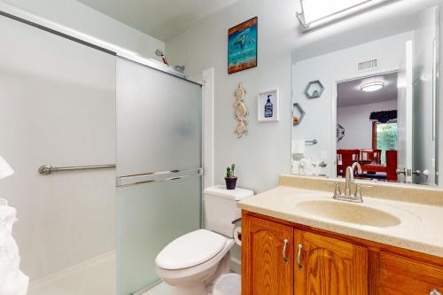 a bathroom with a toilet and a sink and a shower at Bentons Oasis in Ventura