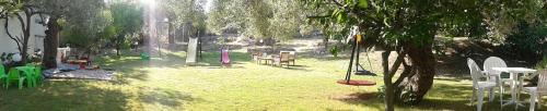 a park with tables and chairs in the grass at Spathies in Kalogria