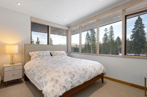 a bedroom with a bed and large windows at Stellar Ski In Ski Out # 2 Northstar Townhome, HOA Amenities in Truckee