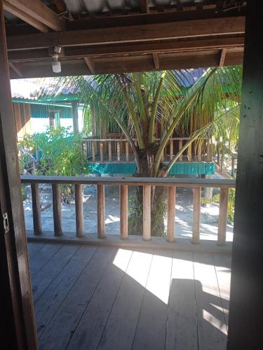 an open porch with a palm tree in the background at Prek Svay Bungalow in Sihanoukville