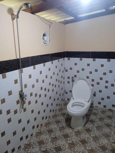 a bathroom with a toilet in a room at Prek Svay Bungalow in Sihanoukville