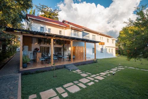 a house with a patio and a yard at Brubru Lodge in Moshi