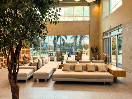 a large room with couches in a building at Ribalta Hotel Barra da Tijuca by Atlantica in Rio de Janeiro
