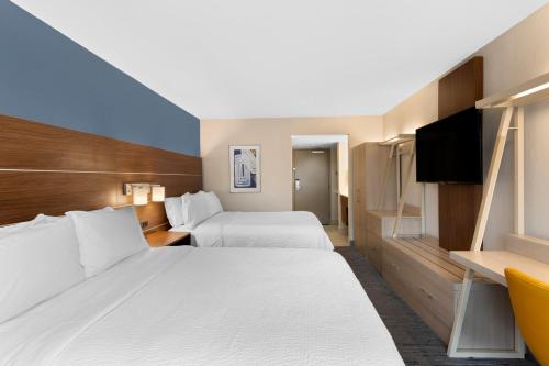 a hotel room with two beds and a television at Holiday Inn Express Hilton Head Island by IHG in Hilton Head Island