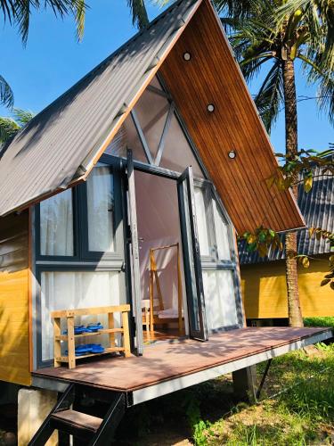 a tiny house on a trailer with a door open at Cóc Retreat Mỹ Tho City in My Tho