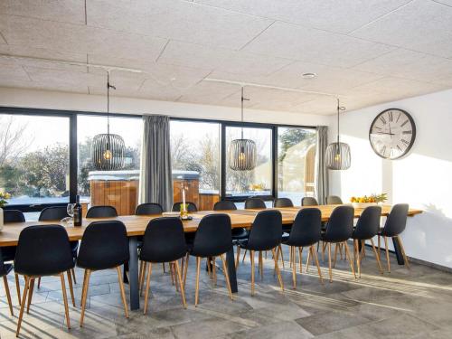 a conference room with a large wooden table and chairs at 4 star holiday home in Ulfborg-By Traum in Ulfborg