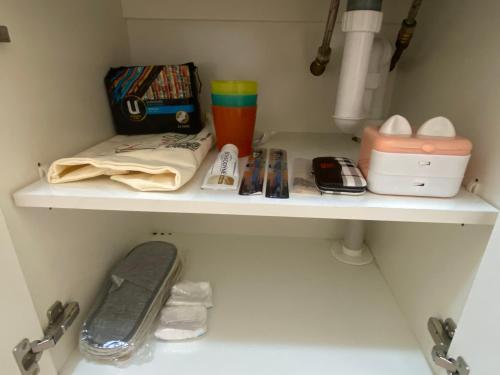 a shelf in a bathroom with items on it at Sunny Ocean View Retreat in Perth