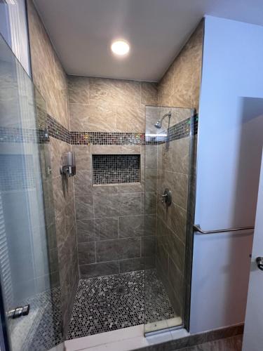 a bathroom with a shower with a glass door at Private Studio in Providence