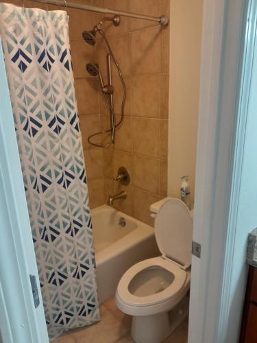 a small bathroom with a toilet and a shower at Luxury Fully Furnished Studio Condo in Atlanta