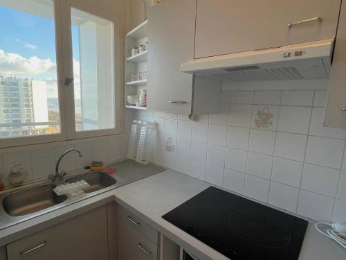 une cuisine avec un évier et une fenêtre dans l'établissement Studio avec balcon, plage à 50m, WIFI, animaux acceptés - FR-1-323-418, à Saint-Jean-de-Monts