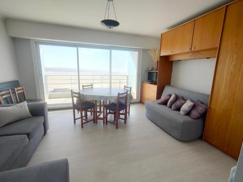 un salon avec une table et un canapé dans l'établissement Studio Confortable pour 3 près Plage, Parking, Cuisine équipée - FR-1-323-459, à Saint-Jean-de-Monts