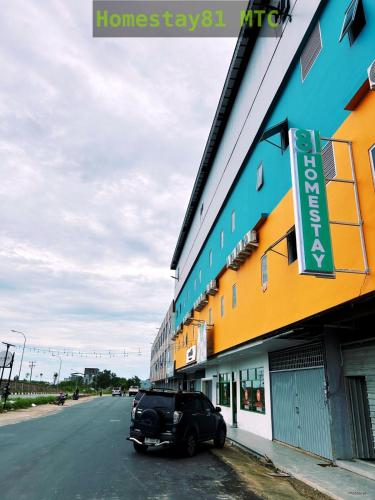 a black car parked in front of a building at Homestay81 MTC in Nongsa