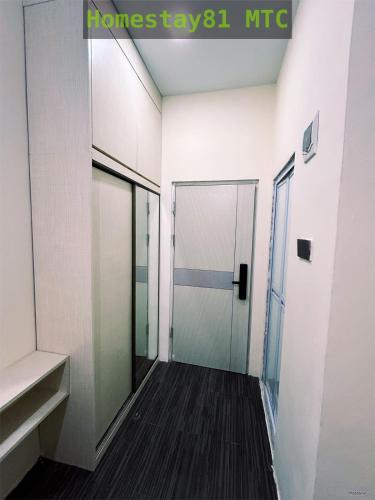 a hallway with a glass door in a building at Homestay81 MTC in Nongsa