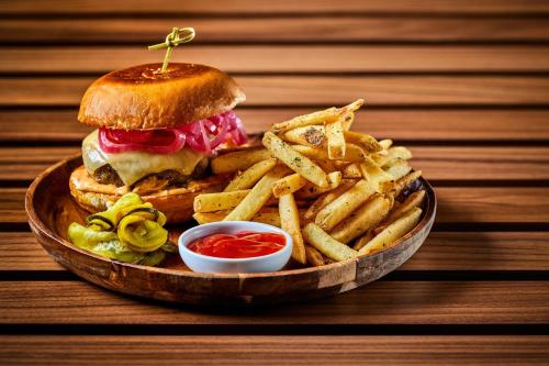 a plate of food with a sandwich and french fries at VEA Newport Beach, a Marriott Resort & Spa in Newport Beach