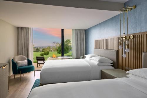 a hotel room with two beds and a window at VEA Newport Beach, a Marriott Resort & Spa in Newport Beach