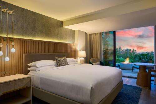 a bedroom with a large bed and a living room at VEA Newport Beach, a Marriott Resort & Spa in Newport Beach