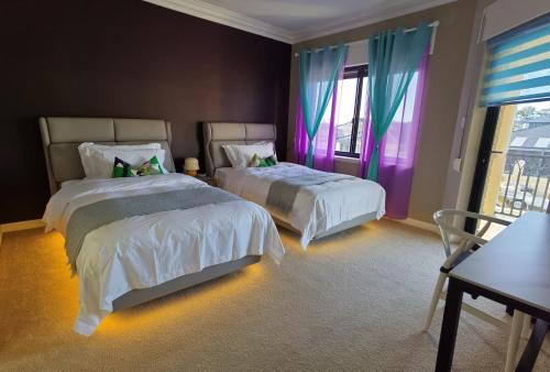 a bedroom with two beds and a window at Sunny Ocean View Retreat in Perth