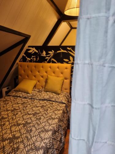 1 dormitorio con cama y cortina azul en ALMA CALMA en San Marcos Sierras