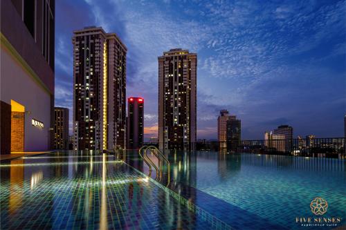 a large swimming pool in a city at night at Chambers Residence, Sunway Putra Mall in Kuala Lumpur