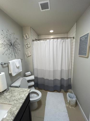 a bathroom with a toilet and a shower at On The Go Stays in Dallas