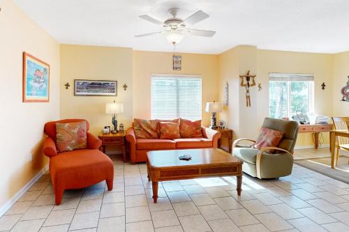 a living room with couches and chairs and a table at South Harbour 2A in Pensacola Beach