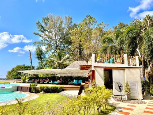 a villa with a swimming pool and a resort at Twin Bay Resort Koh Lanta in Ko Lanta