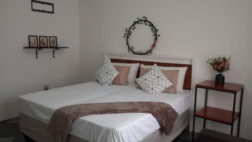 a bedroom with a bed with white sheets and pillows at The garden house in Boksburg