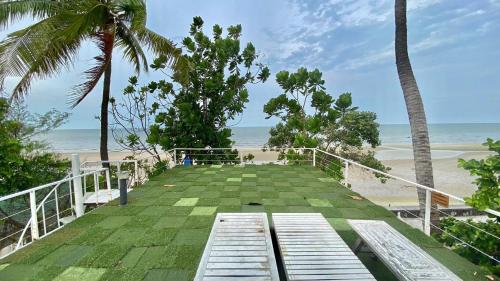 a balcony with a view of the beach at Green Gallery Beach Boutique Hotel in Hua Hin