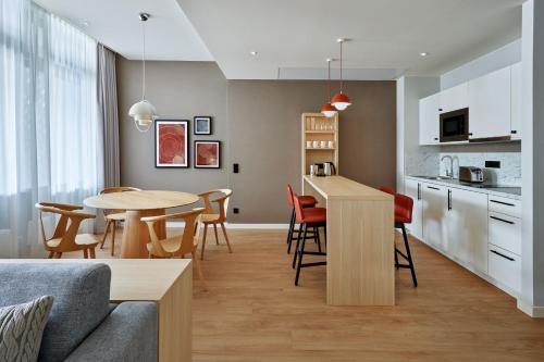 a living room and kitchen with a table and chairs at Residence Inn by Marriott Munich Central in Munich
