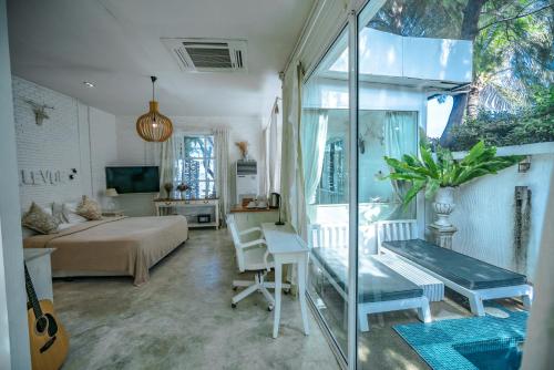 a bedroom with a bed and a desk in a room at Green Gallery Beach Boutique Hotel in Hua Hin