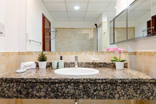 a bathroom counter with a sink and a mirror at Moonlight Hostel JBR in Dubai