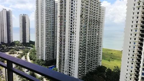 a view of two tall buildings from a balcony at Forest森林城市01 in Kampong Pok Kechil