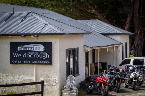 a group of motorcycles parked in front of a building at Weldborough Hotel in Weldborough