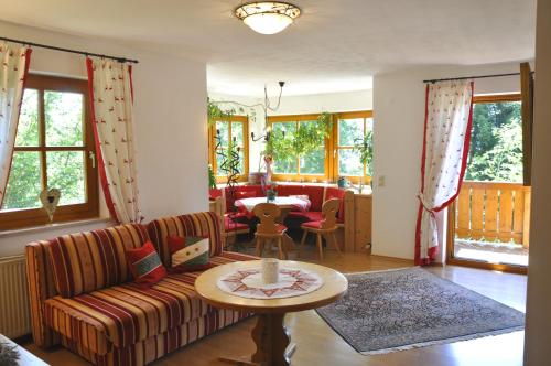 a living room with a couch and a table at Chalet Zauberflöte in Radstadt