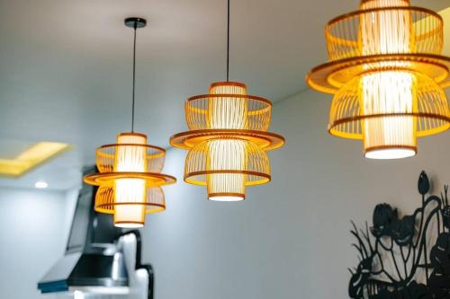a group of lights hanging from the ceiling at Lotus Villa Hoi An - 4 Bedrooms - river view - private pool in An Bang