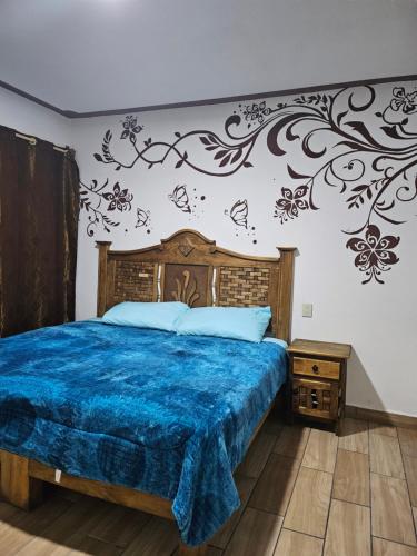 貝納爾的住宿－Posada villa aurora，一间卧室配有一张带蓝色棉被的床