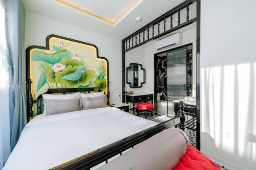 a bedroom with a large bed and a large window at Lotus Villa Hoi An - 4 Bedrooms - river view - private pool in An Bang