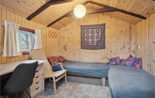 a bedroom with a bed in a wooden room at 3 Bedroom Awesome Home In Silkeborg in Silkeborg