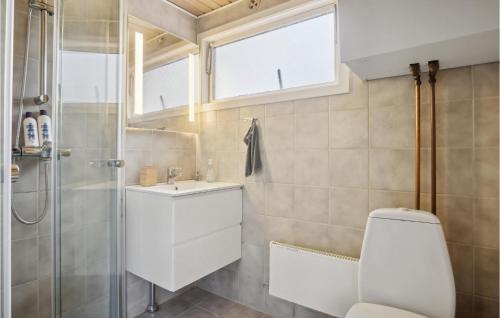a bathroom with a toilet and a sink and a shower at 3 Bedroom Awesome Home In Silkeborg in Silkeborg
