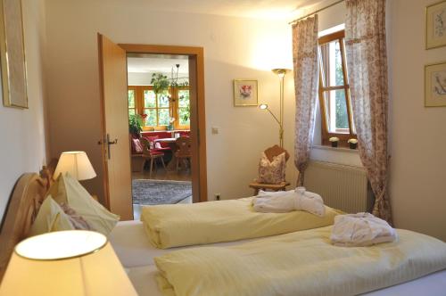 a bedroom with two beds and a dining room at Chalet Zauberflöte in Radstadt