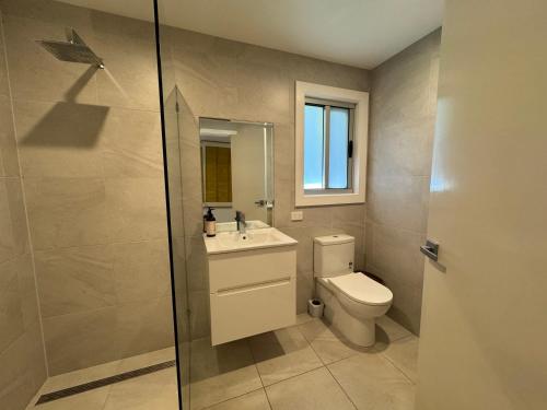 a bathroom with a toilet and a sink and a shower at No 34 Where Nature Meets the Ocean Pet Friendly in Robe