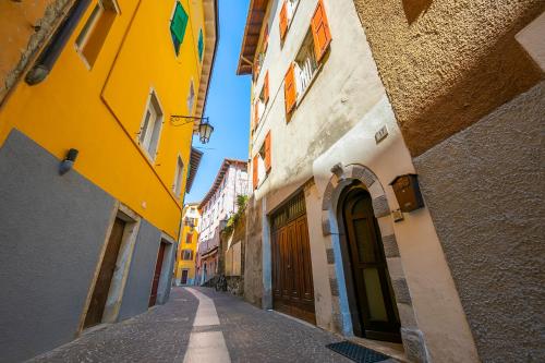 an alley between two buildings in a city at Appartamento Miorelli - Happy Rentals in Nago-Torbole