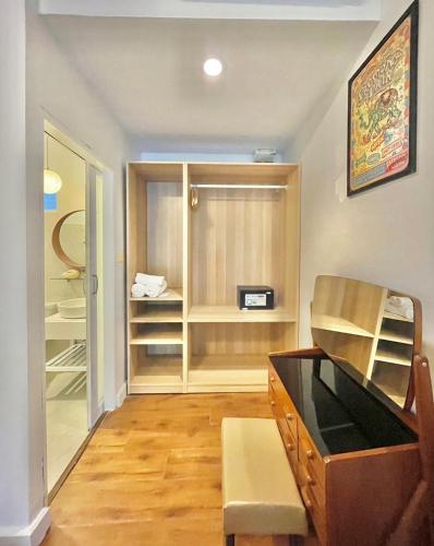 a room with a desk and a closet at Green Gallery Beach Boutique Hotel in Hua Hin