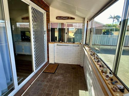 an empty room with a view of a balcony at Driftwood - Bunbury in Bunbury
