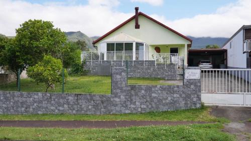 a house with a stone retaining wall at L'Idolivier in La Plaine des Palmistes