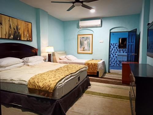 1 Schlafzimmer mit 2 Betten und einem Deckenventilator in der Unterkunft ARAU HERITAGE INN in Arau